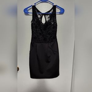 Black, small, thigh-high dress, silk skirt with pockets and lace top.